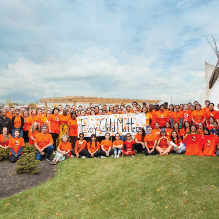 group photo in front of a teepee outdoor