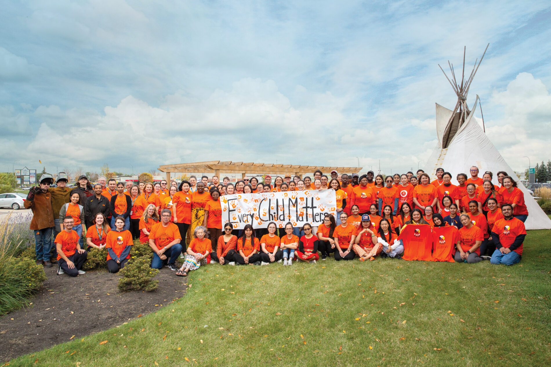 group photo in front of a teepee outdoor