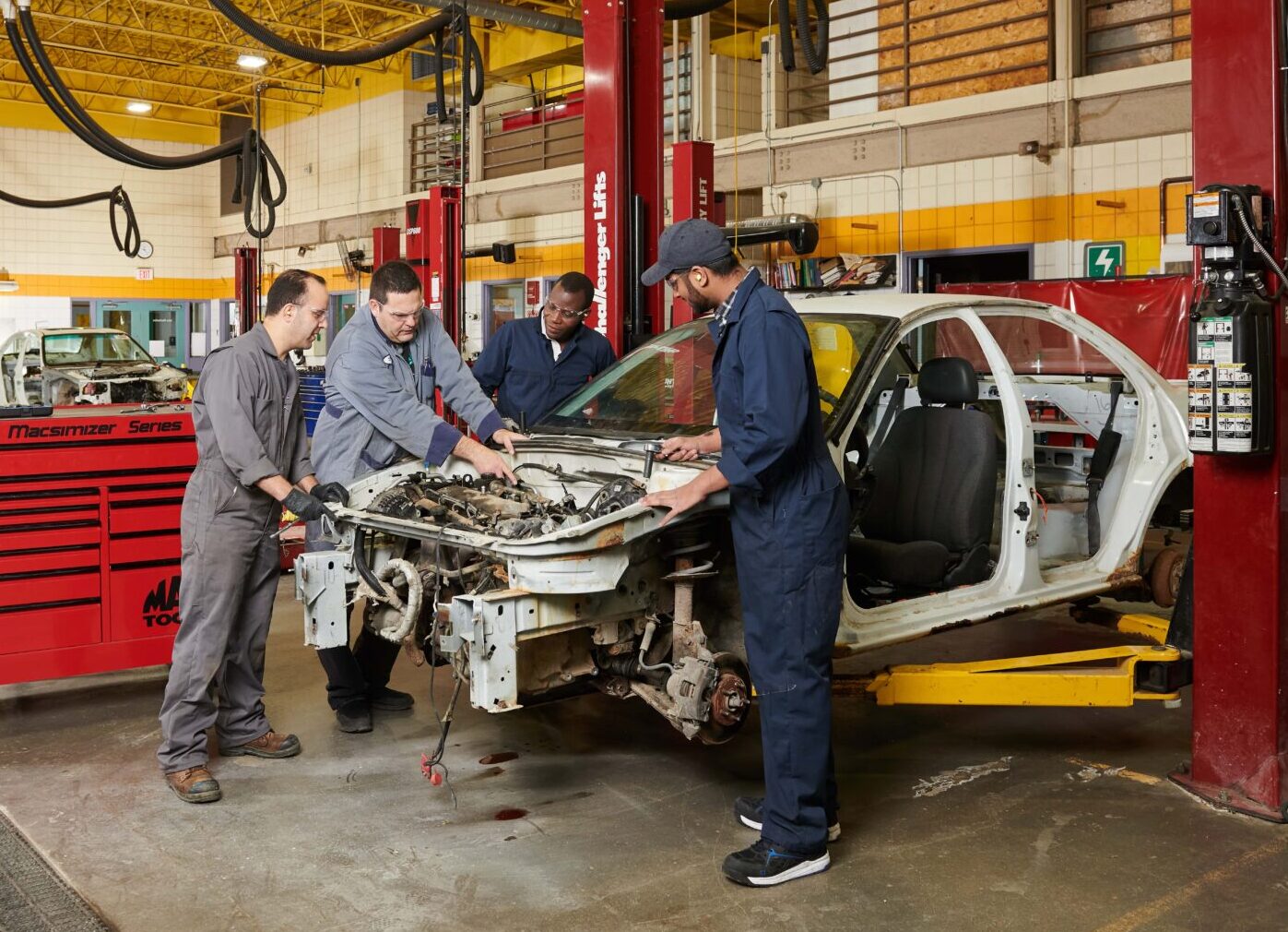 students working on a car