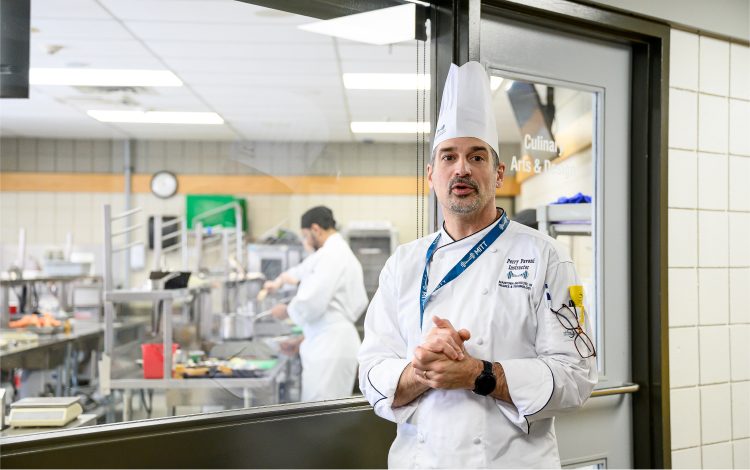 Chef standing in front of a commercial kitchen