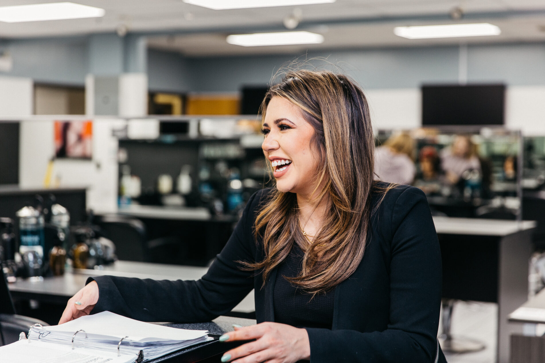 Woman in front of binder smiling
