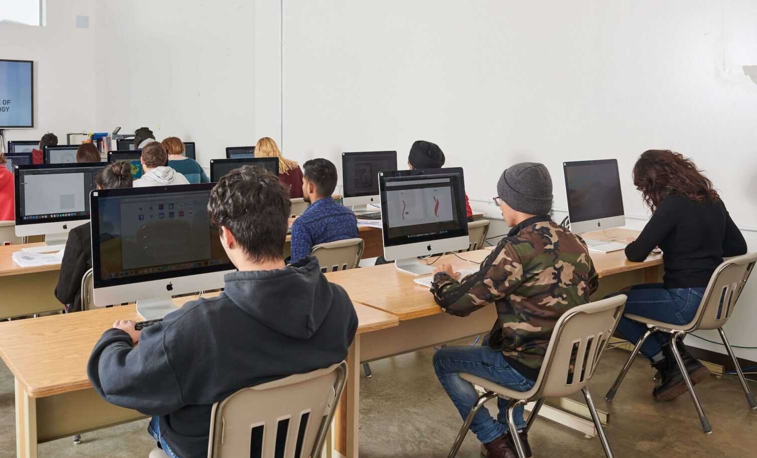 Students sitting in lecture hall listening to instructor