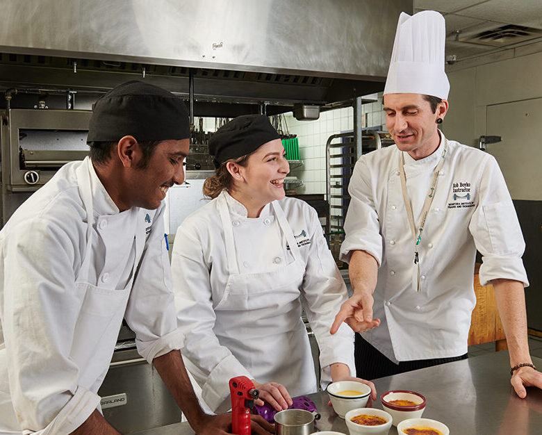 Culinary arts instructor talking to students