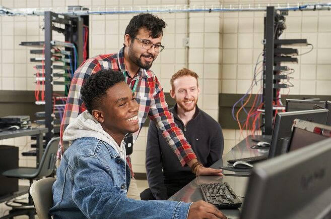 Students in a computer lab looking at a computer screen