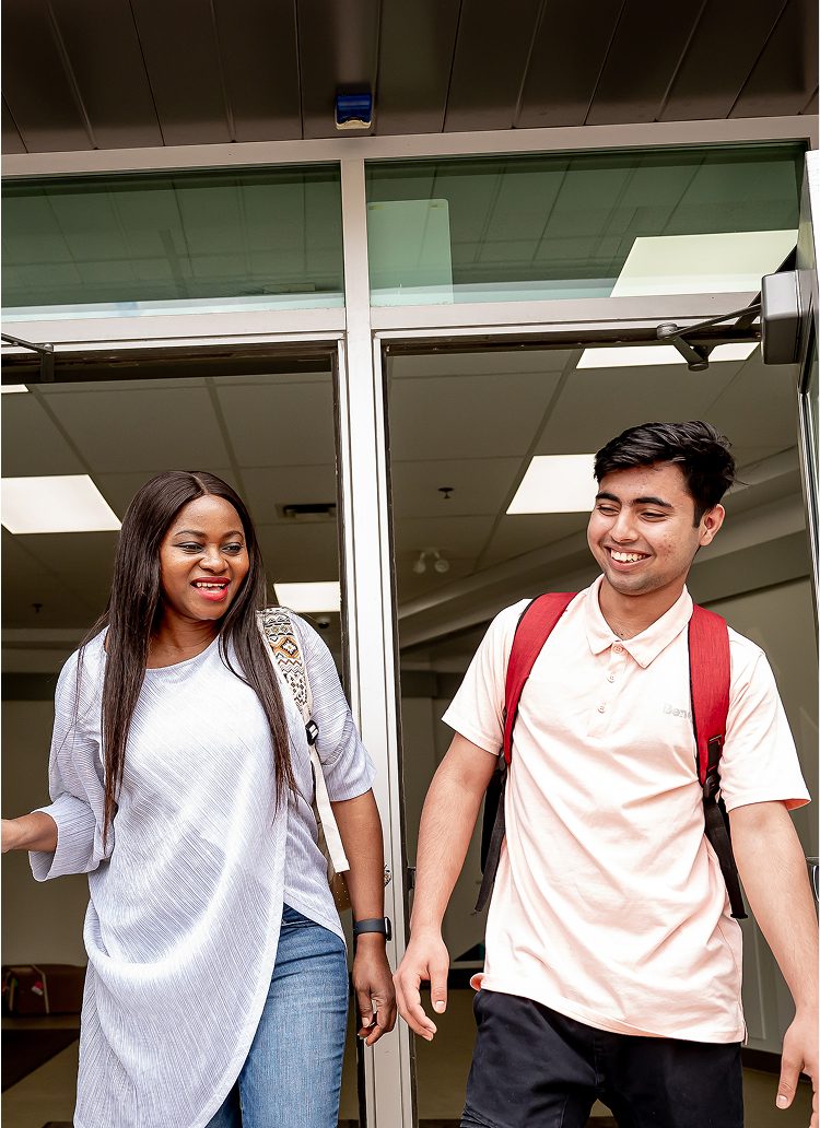 students in front of school building