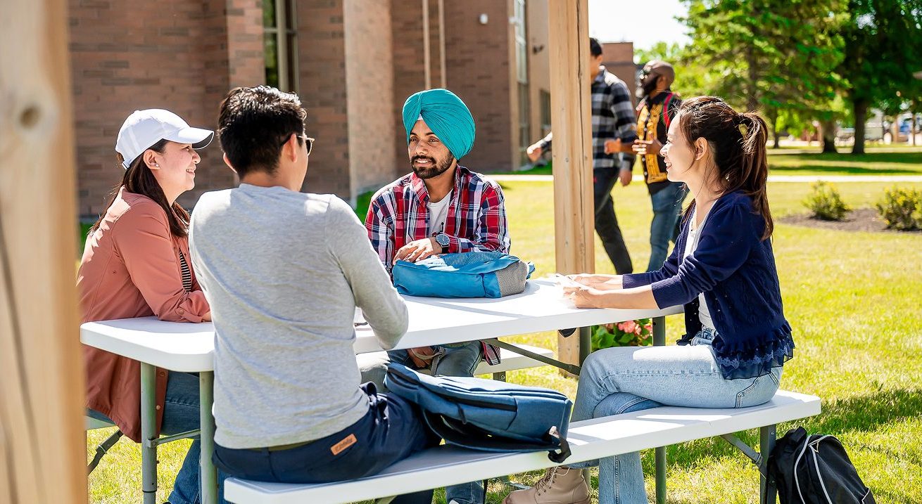students sitting at a picnic table