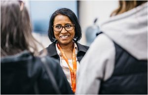 woman with 2 other people smiling