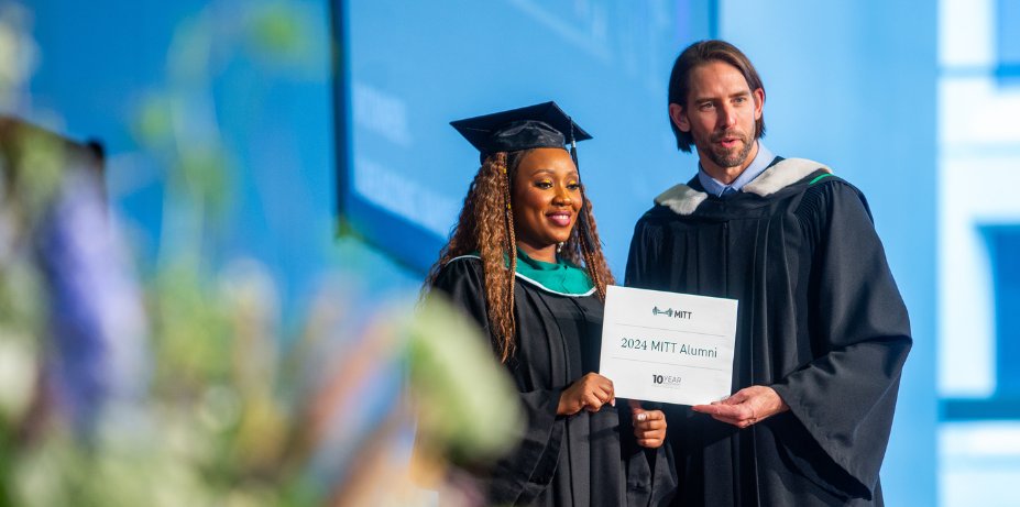 Graduates showing off diploma