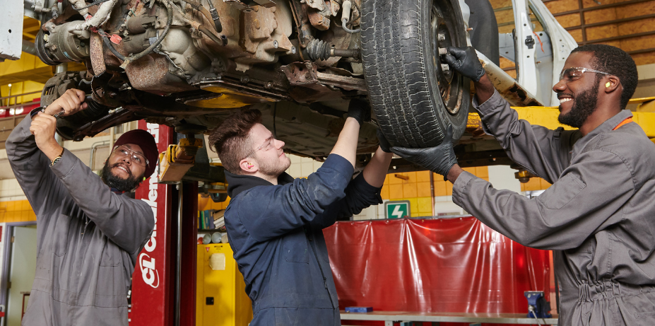 Students working on raised car