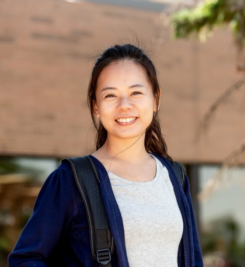 student with backpack smiling