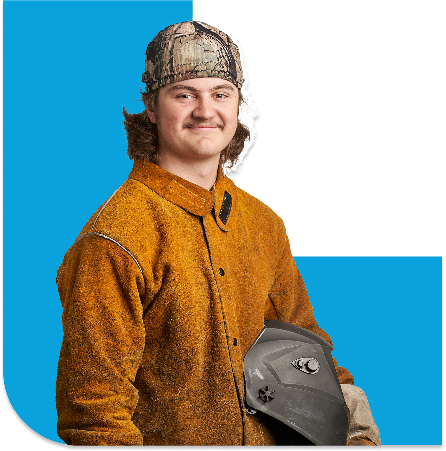 Student holding welder helmet