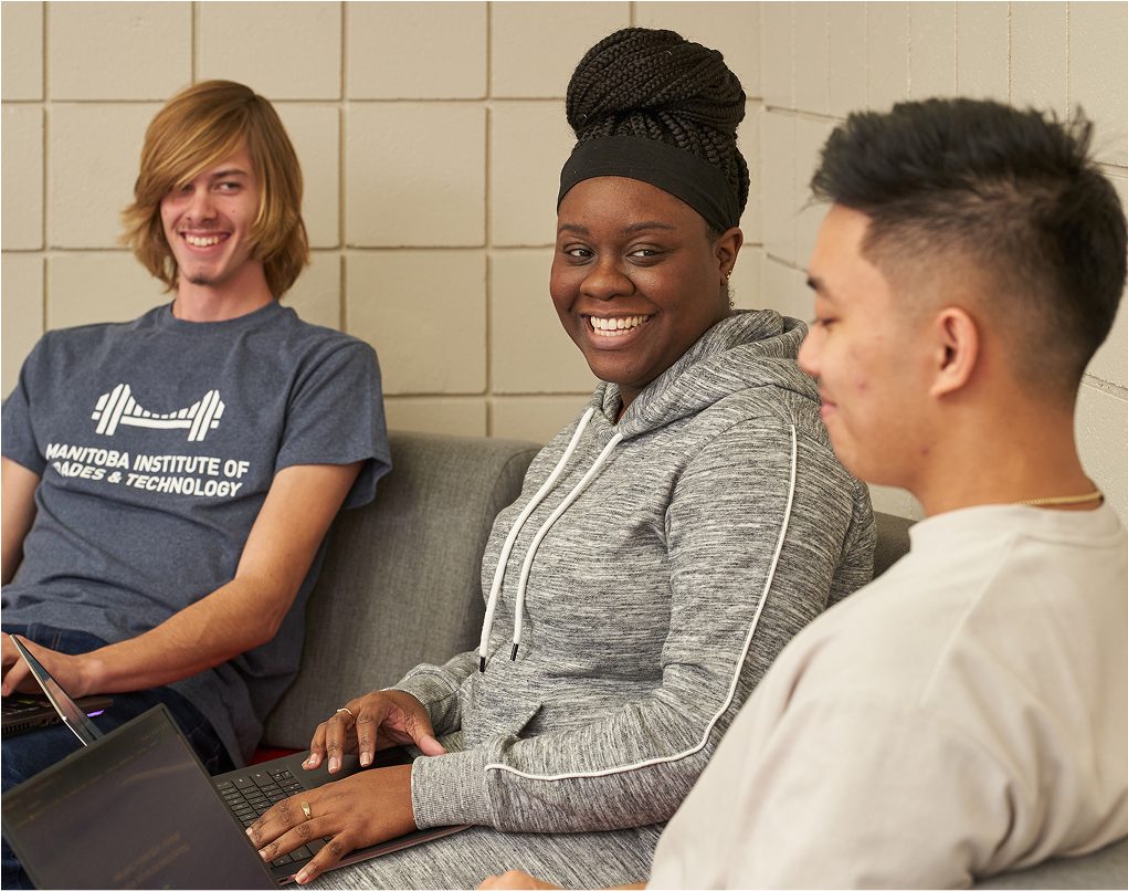 students sitting on couch looking at eachother